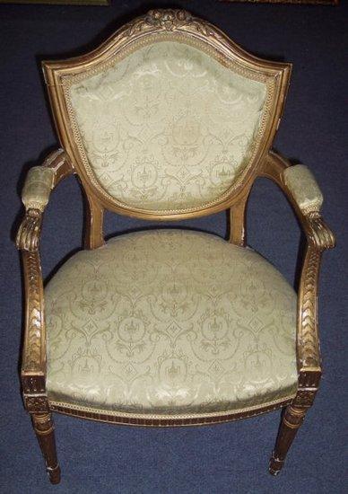 Appraisal: A Louis XVI style shield back open armchair with padded