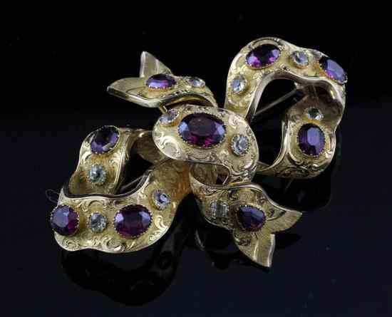 Appraisal: A Victorian gold almandine garnet and aquamarine brooch of ribbon