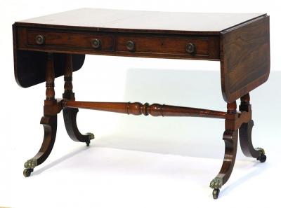 Appraisal: A REGENCY ROSEWOOD SOFA TABLE of rounded oblong form with