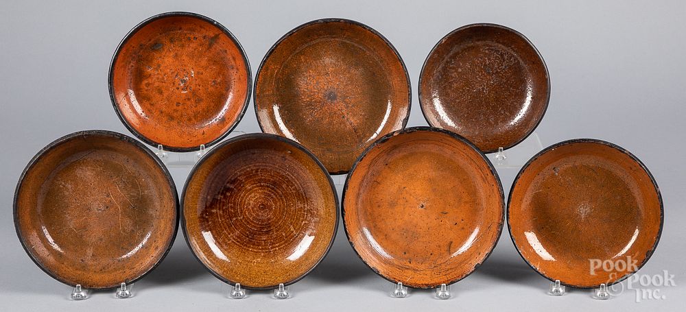 Appraisal: Thirteen redware plates and shallow bowls th c Thirteen redware