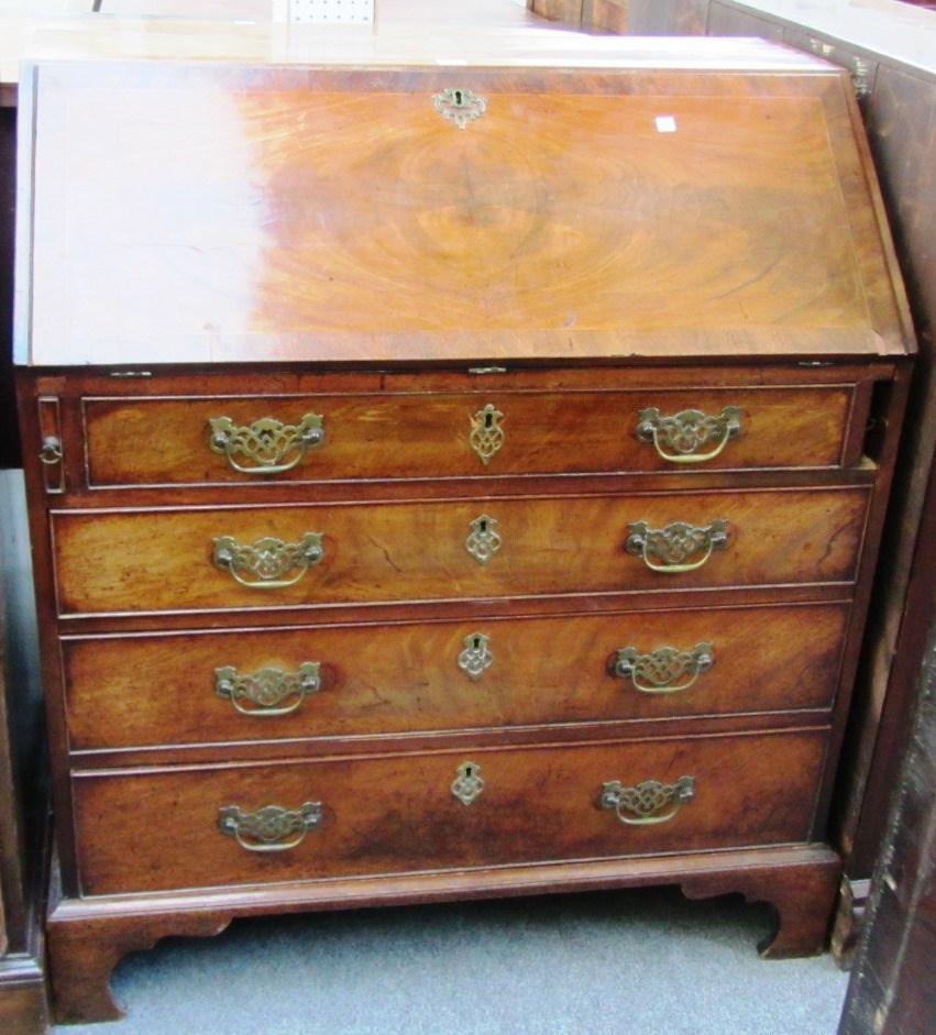 Appraisal: A George III mahogany bureau the fall enclosing a fitted