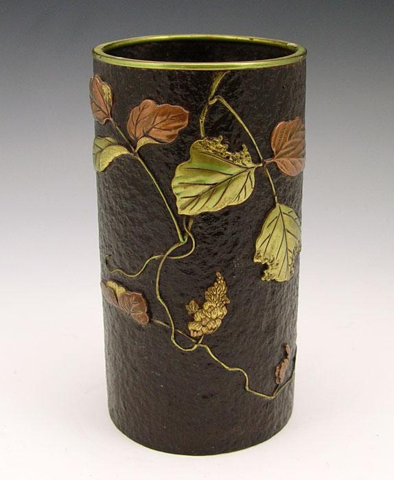 Appraisal: MIXED METAL CYLINDER VASE WITH APPLIED FLOWERS Unsigned '' h