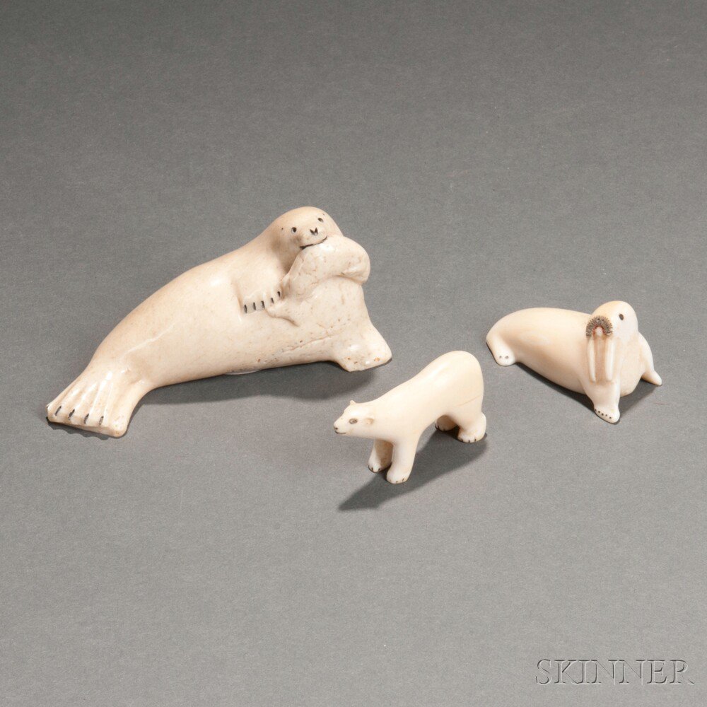 Appraisal: Three Eskimo Carved Walrus Tusk Animals a seal with a