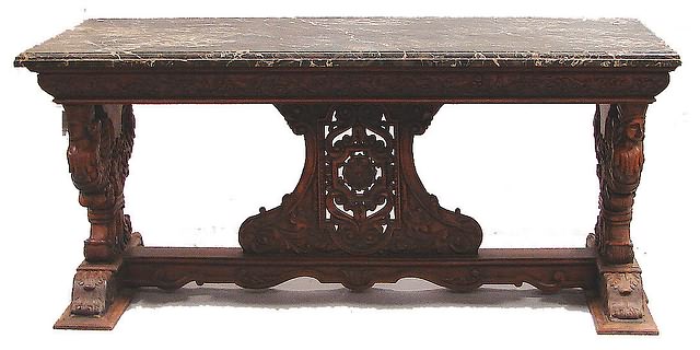 Appraisal: Beveled edge black marble top on a heavily carved walnut