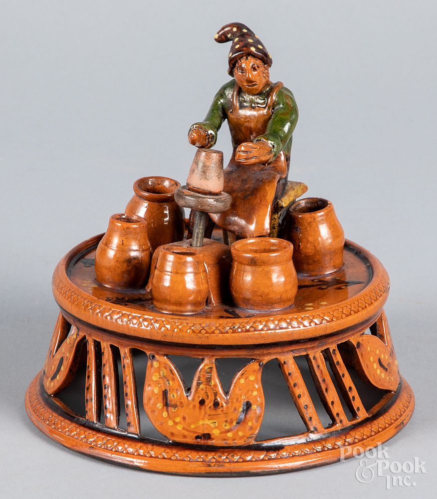 Appraisal: Shooner redware figure of a potter at his wheel Shooner