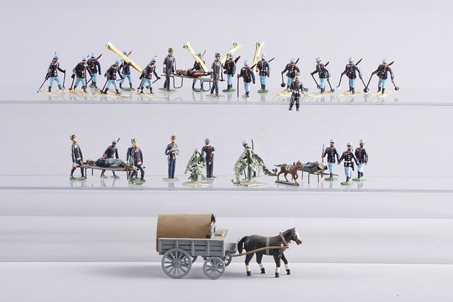 Appraisal: Lot of Heyde-type figures representing Alpine Ski Troops includes cart