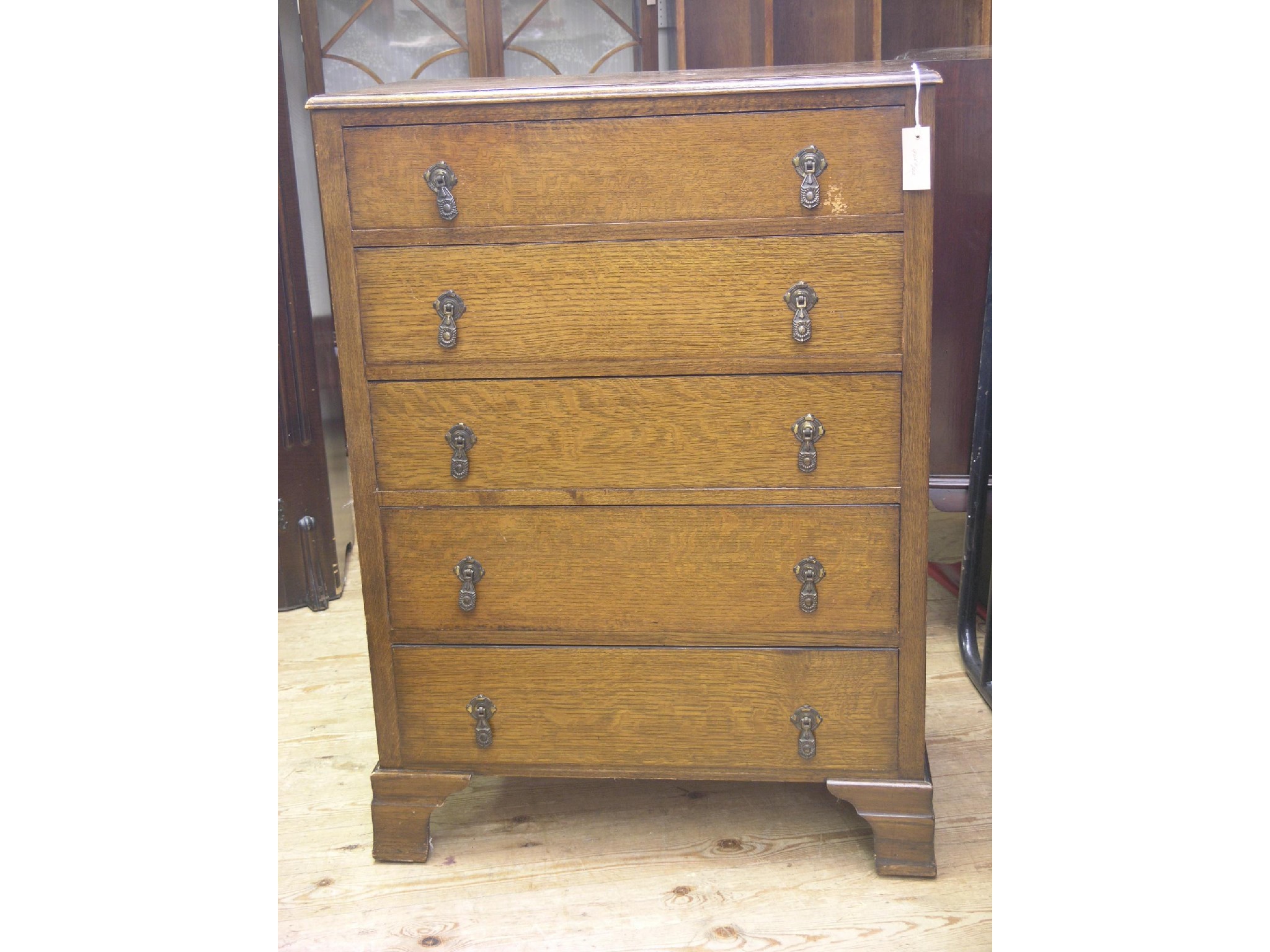 Appraisal: A dark oak-veneered chest five long drawers ft in