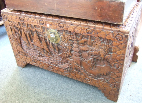 Appraisal: An early th century carved champhor wood trunk raised on