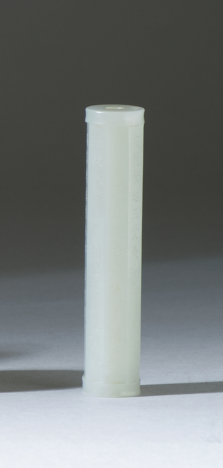 Appraisal: WHITE JADE OCTAGONAL CYLINDER With finely engraved calligraphy Length cm