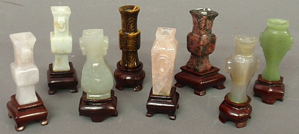 Appraisal: - Eight oriental carved stone miniature vases on wood stands