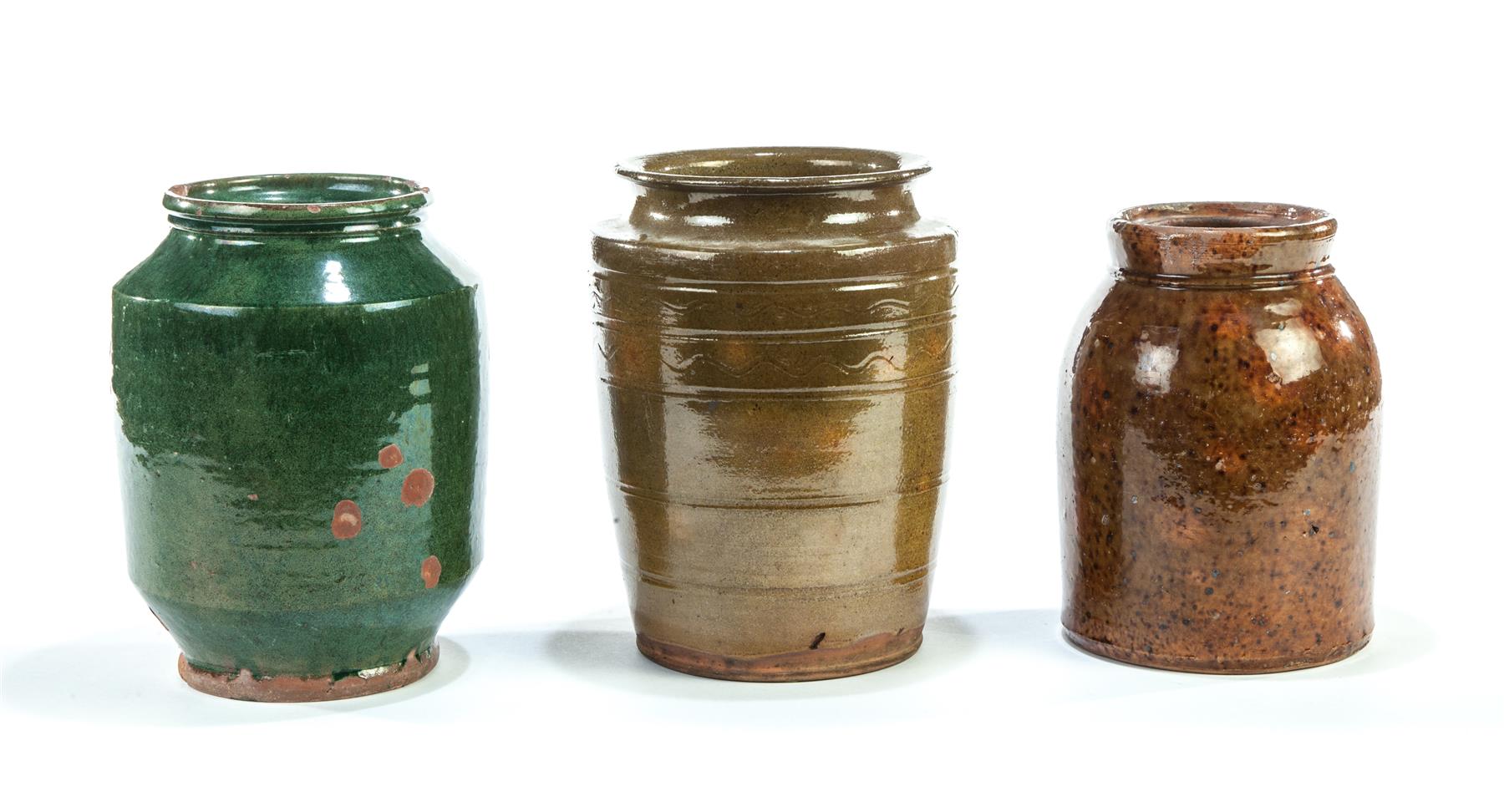 Appraisal: THREE AMERICAN REDWARE JARS Mid th century Incised line decoration