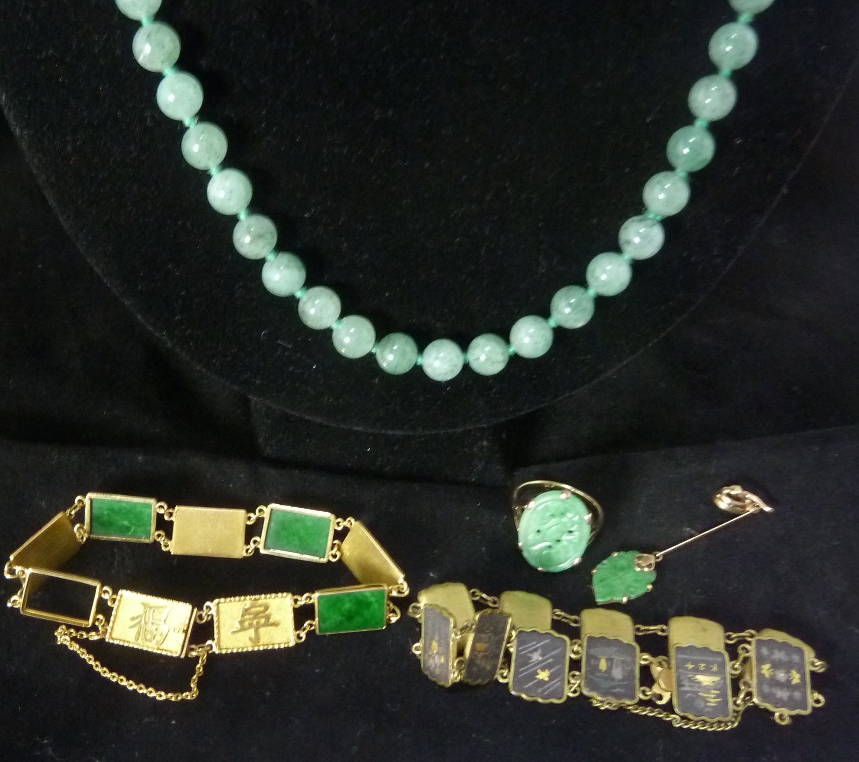 Appraisal: A Chinese gold and green hardstone panel bracelet possibly Wang