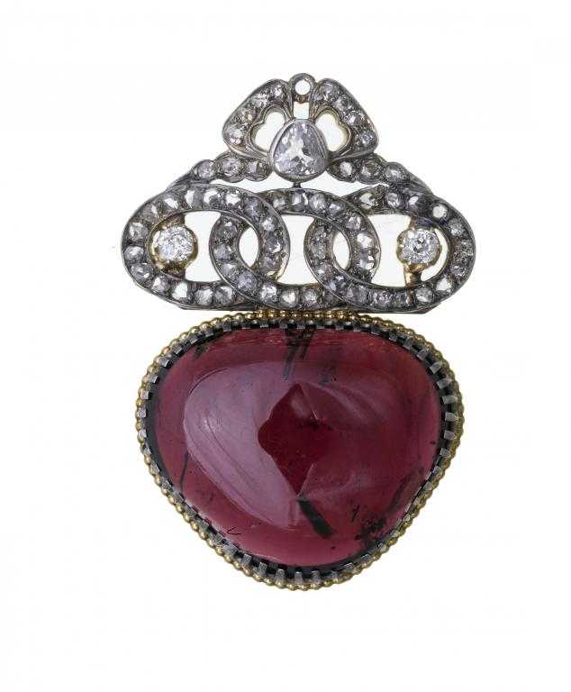 Appraisal: A DIAMOND AND GARNET PENDANT the larger almost heart shaped