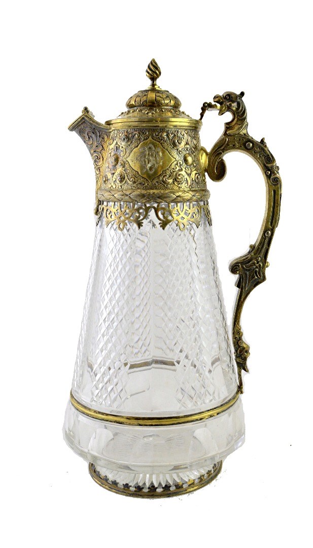 Appraisal: A Victorian cut glass claret jug with chased silver gilt