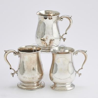 Appraisal: THREE ENGLISH STERLING MUGS WITH SCROLL HANDLES William Gould London