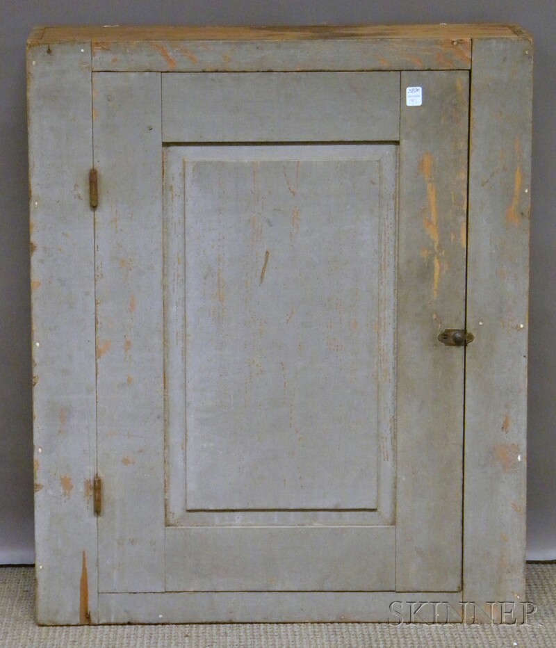 Appraisal: Gray-painted Pine Wall Cupboard with Paneled Door the interior with