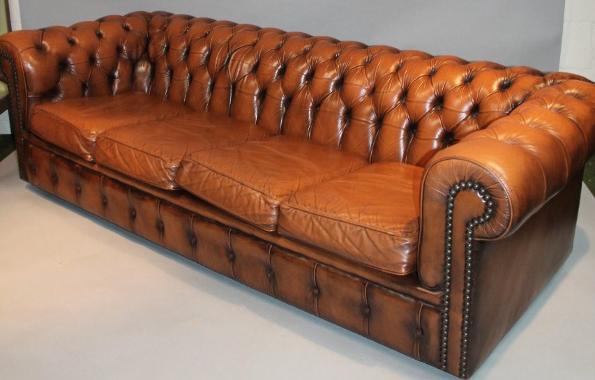 Appraisal: A thC tan leather button back Chesterfield settee the D-end