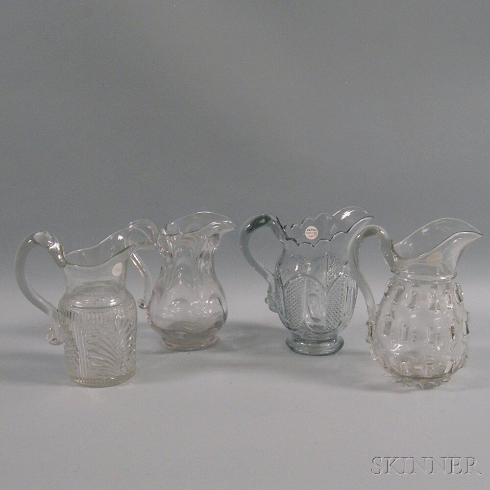 Appraisal: Four Colorless Flint Glass Water Pitchers ht to in Estimate