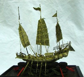 Appraisal: A cased figure of a Chinese war junk in white