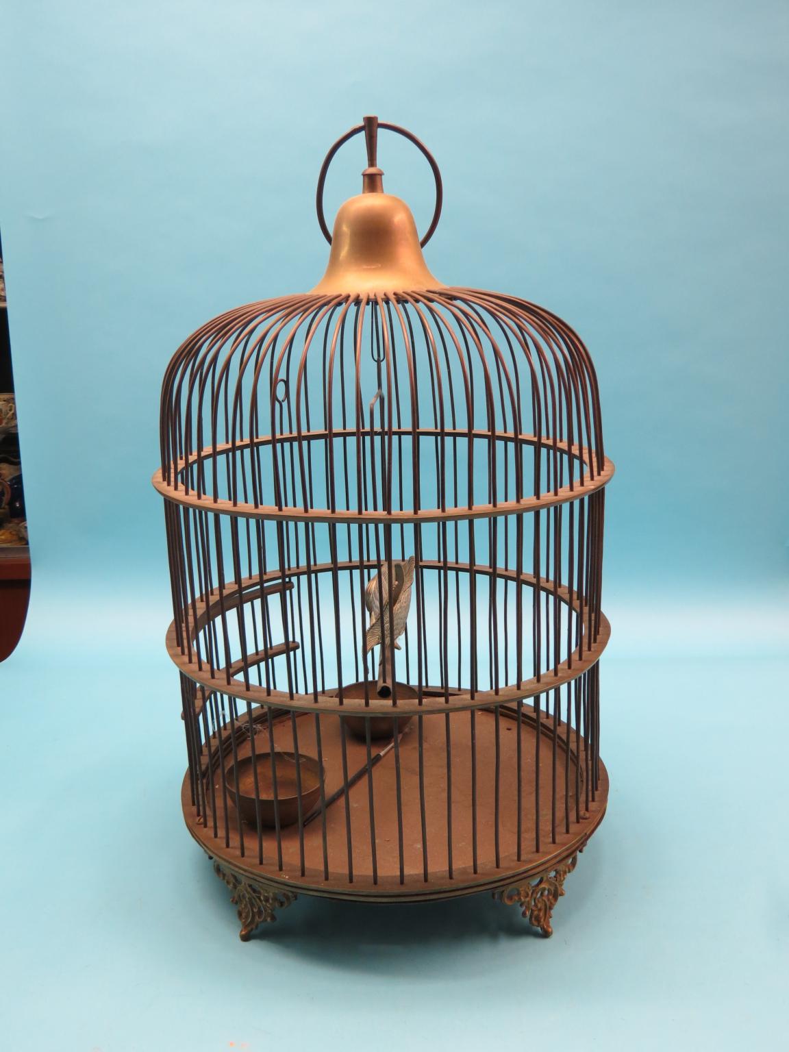 Appraisal: A large Victorian brass bird cage domed-shape with enclosed swing