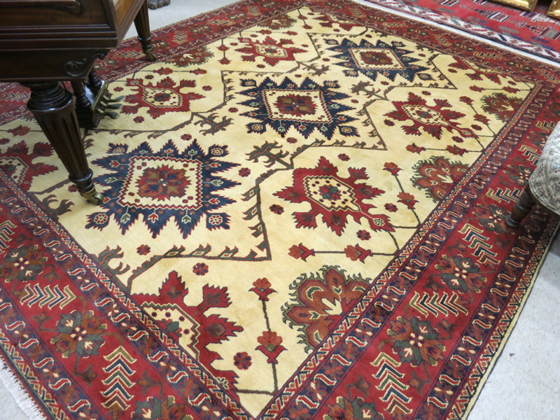 Appraisal: HAND KNOTTED ORIENTAL CARPET Pakistani Caucasian multiple geometric medallion and