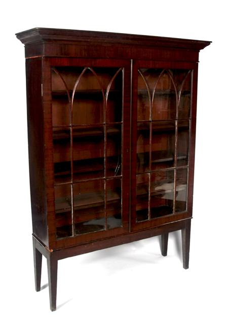 Appraisal: A George III mahogany bookcase on later stand the projected