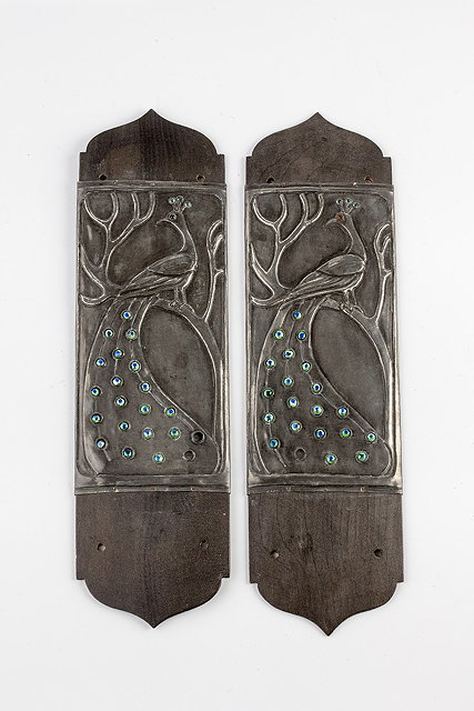 Appraisal: Arts CraftsPair of finger platesdecorated with peacocks sitting upon a