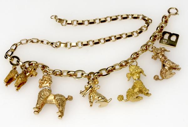 Appraisal: GOLD POODLE CHARM NECKLACE BRACELET k yg with five sculptural