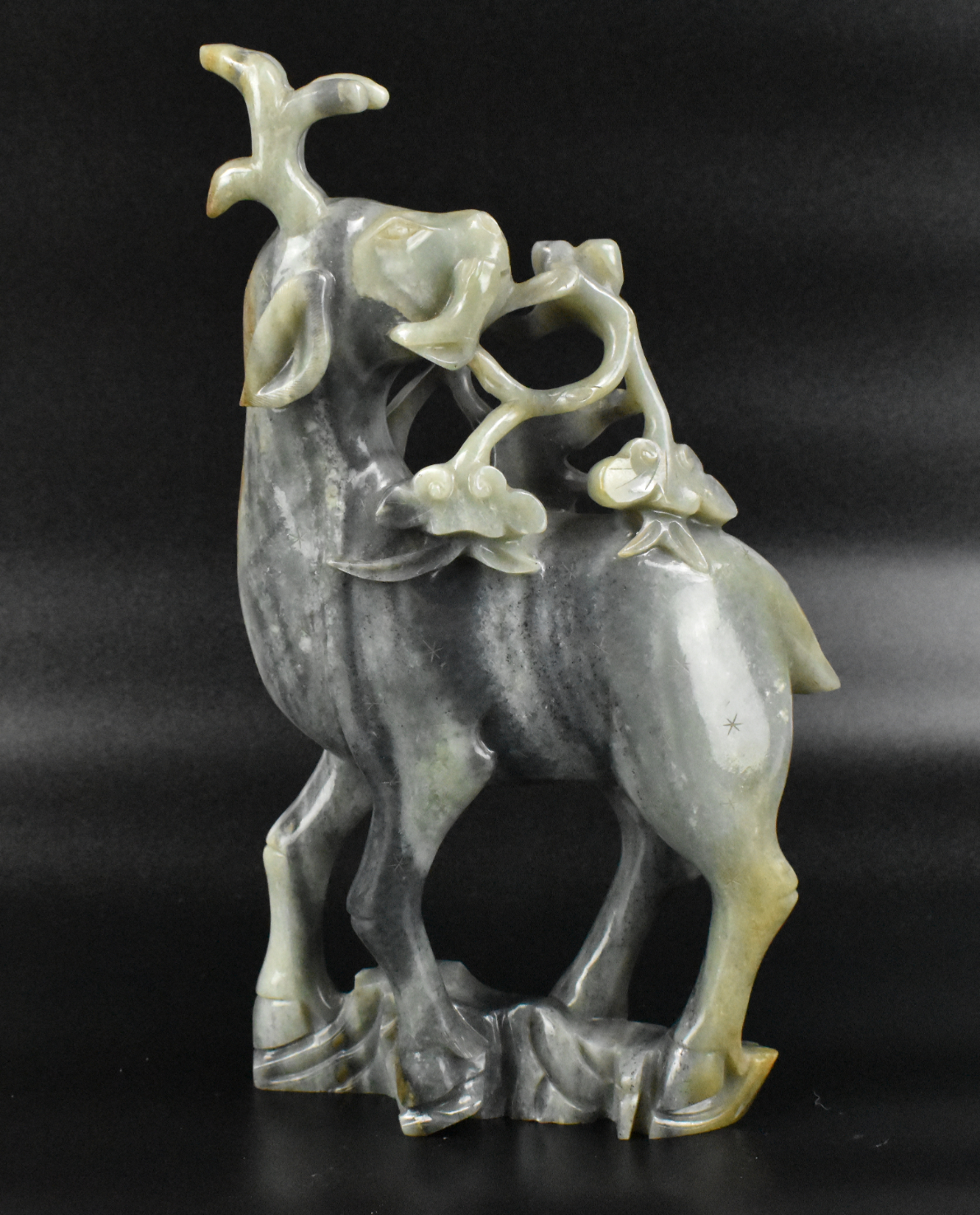 Appraisal: A Chinese jadeite carving of deer Upright deer figure on