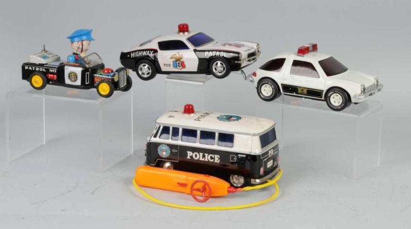 Appraisal: Lot of Tin Pressed Steel Police Car Toys Description Working