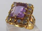 Appraisal: A yellow metal tests carat gold amethyst and opal ring