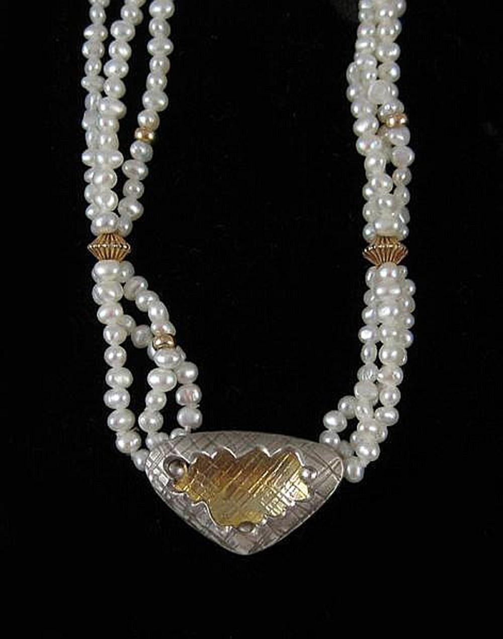 Appraisal: DESIGNER PEARL STERLING AND YELLOW GOLD NECKLACE The triple strand