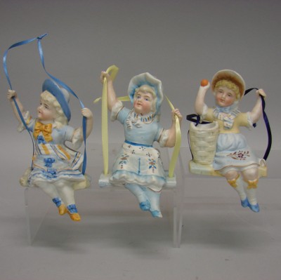 Appraisal: Lot of all bisque sitting girl swing figurines Unmarked dressed