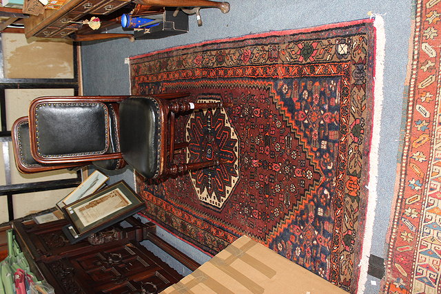 Appraisal: A HAMADAN BLUE AND RED GROUND RUG with banded border