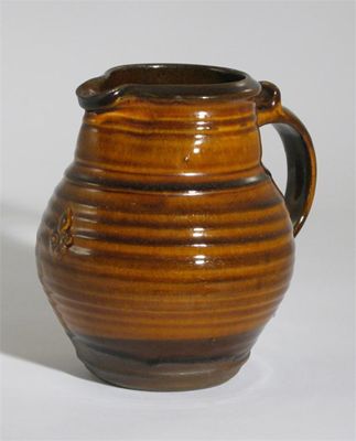 Appraisal: Leach Pottery a stoneware jug with applied fleur de lys