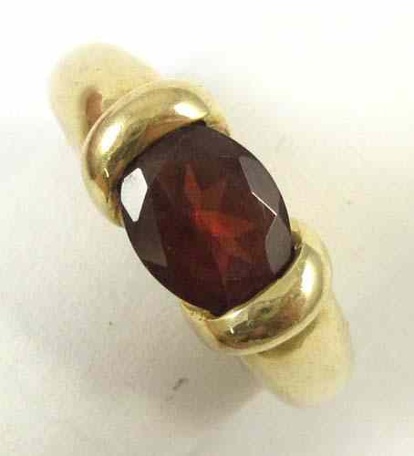 Appraisal: GARNET AND FOURTEEN KARAT GOLD SOLITAIRE RING set with a