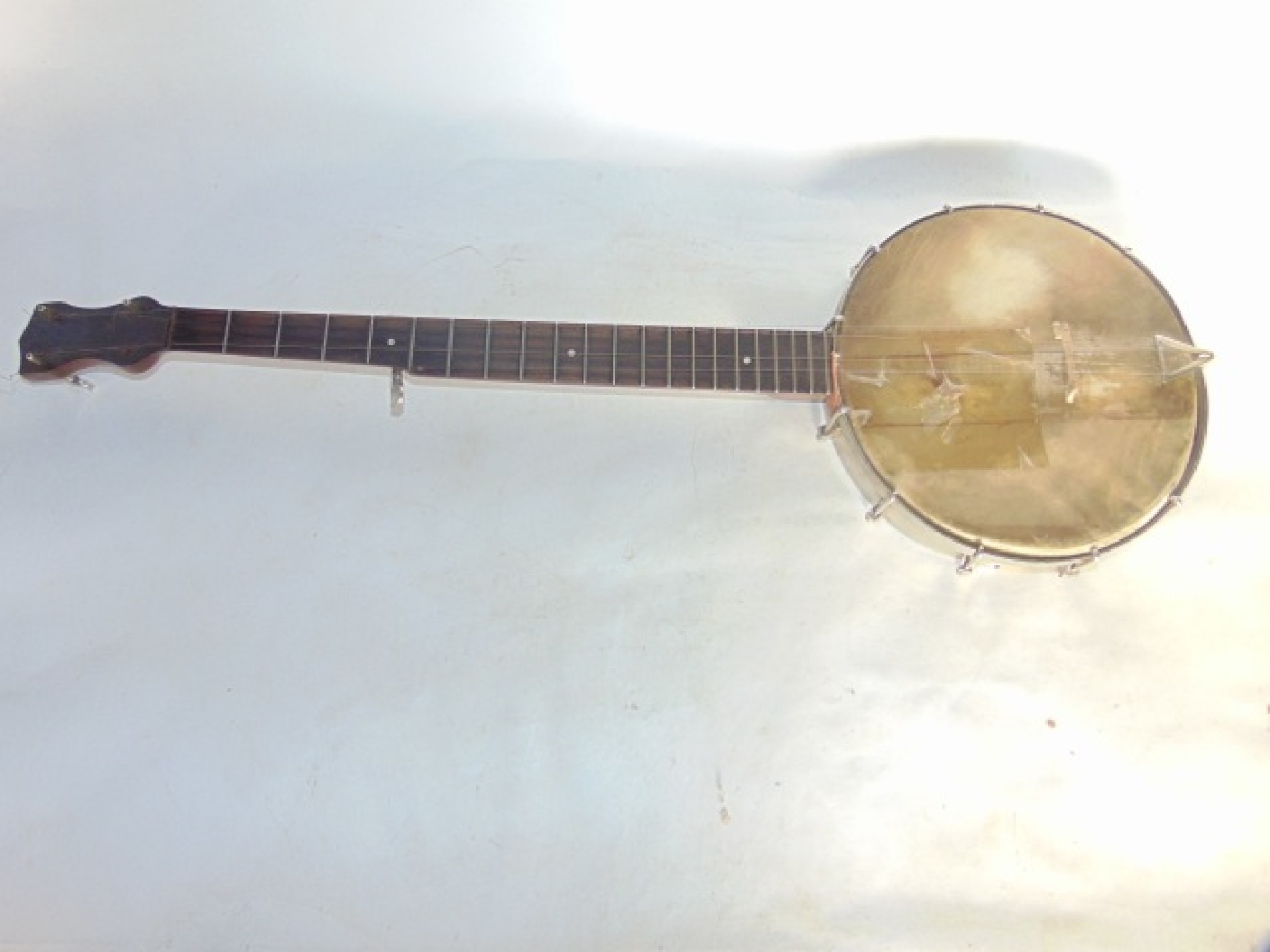 Appraisal: A vintage five string banjo with stretched hide drum stamped