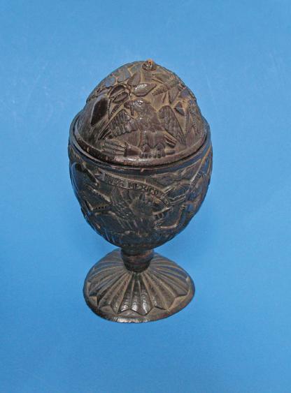 Appraisal: MEXICO - COMMEMORATIVE A carved coconut cup with domed cover