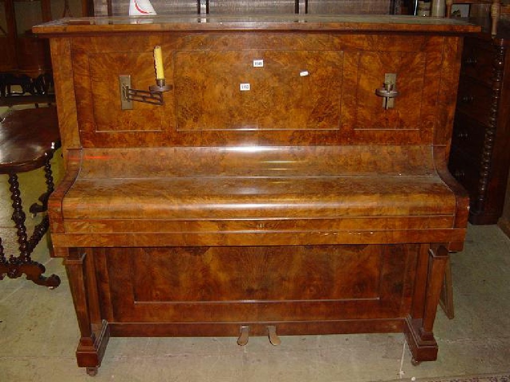 Appraisal: A German upright iron framed and overstrung piano with walnut