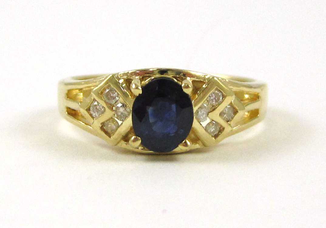 Appraisal: SAPPHIRE DIAMOND AND FOURTEEN KARAT GOLD RING with four round-cut