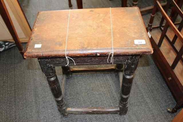 Appraisal: AN OLD JOINTED OAK STOOL the turned legs united by