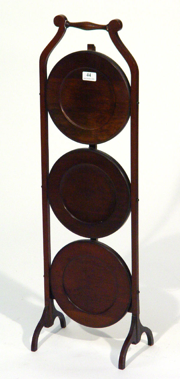 Appraisal: Edwardian mahogany three tier folding cake stand stands cm high