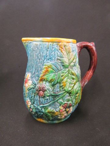 Appraisal: Majolica Pottery Pitcher floral on blue bark texture