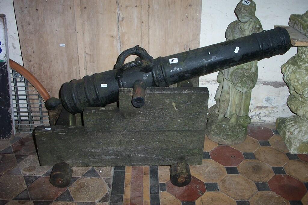 Appraisal: A reproduction cast iron cannon with relief detail and lettering