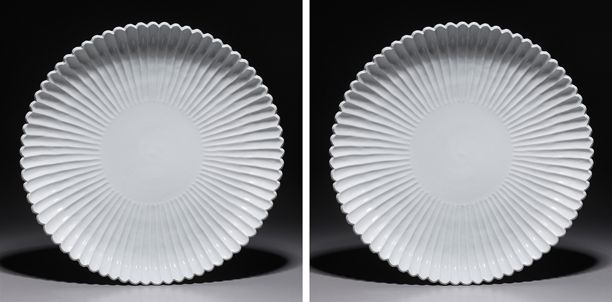 Appraisal: Two Chinese white glazed porcelain chargers with scallop rim H