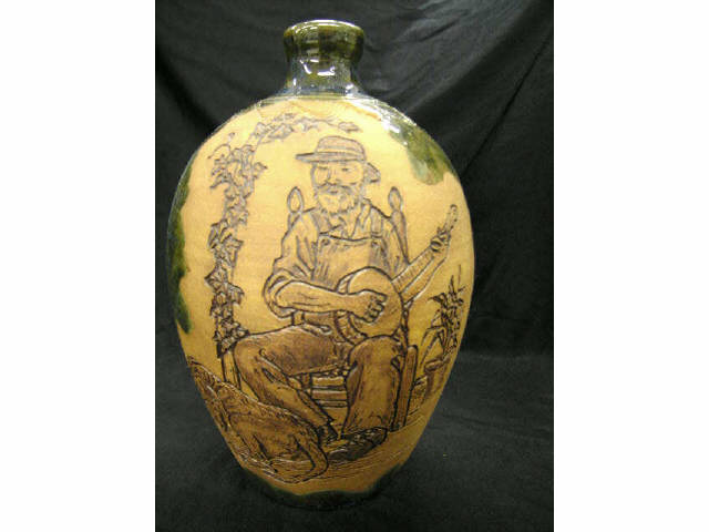 Appraisal: Rodney Leftwich Folk Pottery Jug seated banjo player