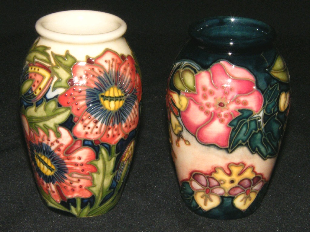 Appraisal: Two similar small Moorcroft modern vases each tube line decorated