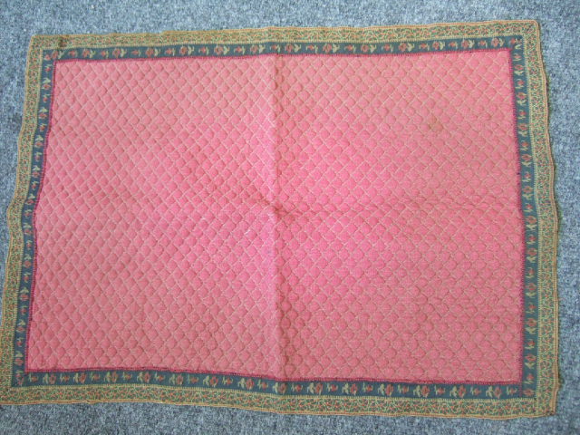 Appraisal: A quilted panel red ground with floral border late th