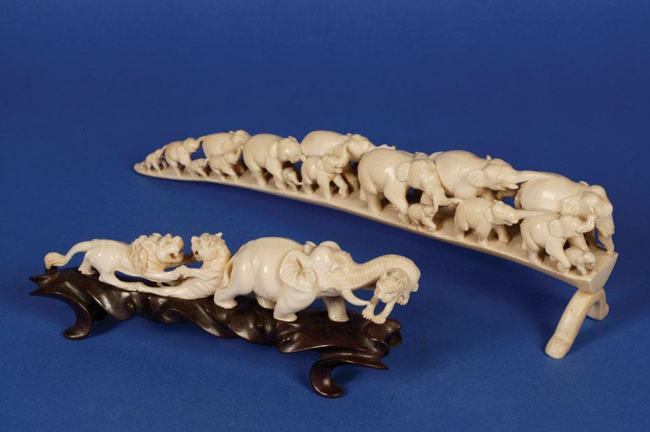 Appraisal: AN IVORY CARVING OF AN ELEPHANT CARRYING A TIGER and