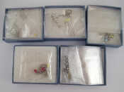 Appraisal: A mixed lot comprising five white metal tests silver pendants